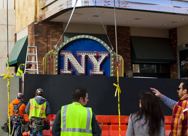 The New York - New York Hotel & Casino marquee entrance sign rests on a flatbed after being taken down by Yesco and donated to the Neon Museum on Tuesday, Jan. 7, 2014.
